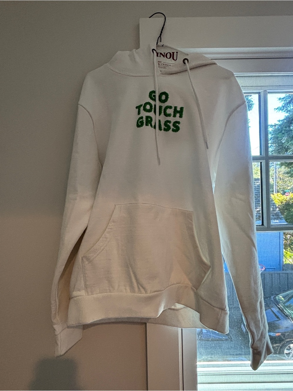 White Hoodie with Green "Go Touch Grass" Text
